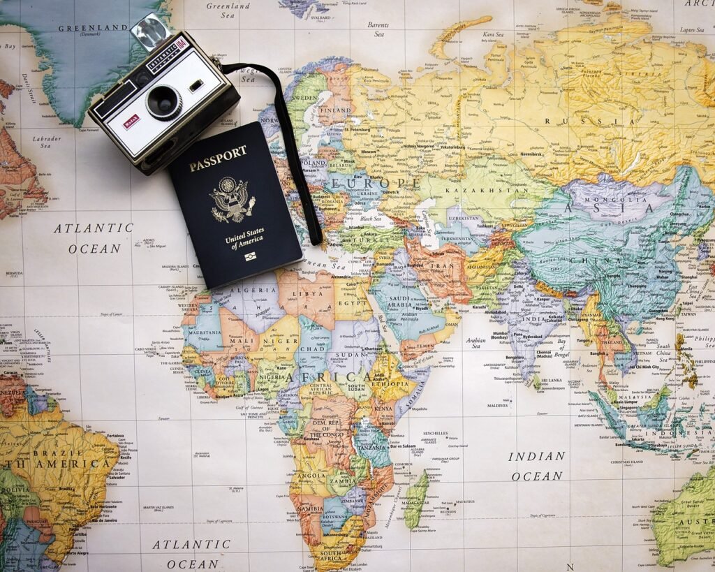 A map of the world with a camera and a passport A map of the world with a camera and a passport