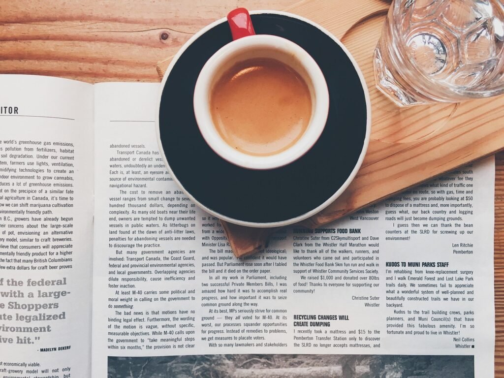 Coffee Mug on top of a newspaper article Coffee Mug on top of a newspaper article