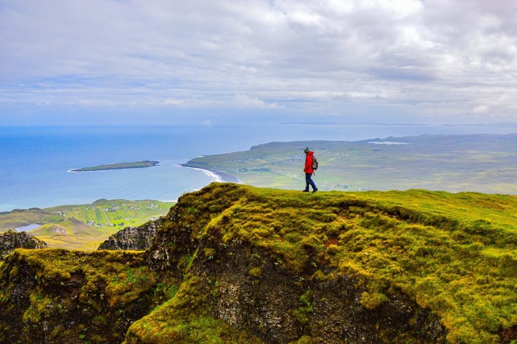 A man solo hiking on the top of a cliff A man solo hiking on the top of a cliff